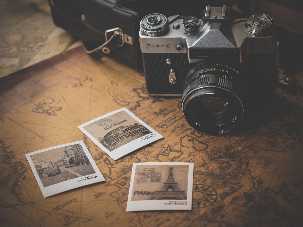 Professional camera lenses and photography equipment on a wooden desk